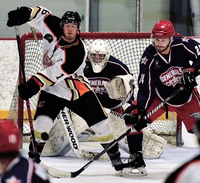 Cochrane Generals goalie Ty Robinson tries to keep his eyes on the puck during a goalmouth scramble in his team&#8217;s 6- 2 win over Coaldale Copperheads on March 1.