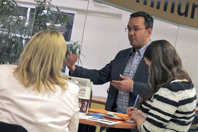 Blake Richards (center), MP for the Banff-Airdrie constituency, discusses federal budget concerns with Cochrane residents at the Cochrane Toyota on Monday, Feb. 29. Richards