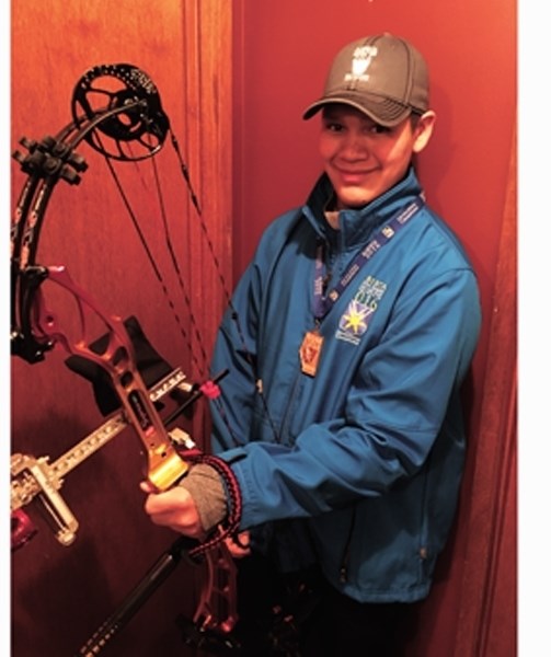 Warren Collins poses with his compound bow and gold medal at the Alberta Winter Games which were held in Medicine Hat on Feb. 13-16. It was the 13-year-old&#8217;s first
