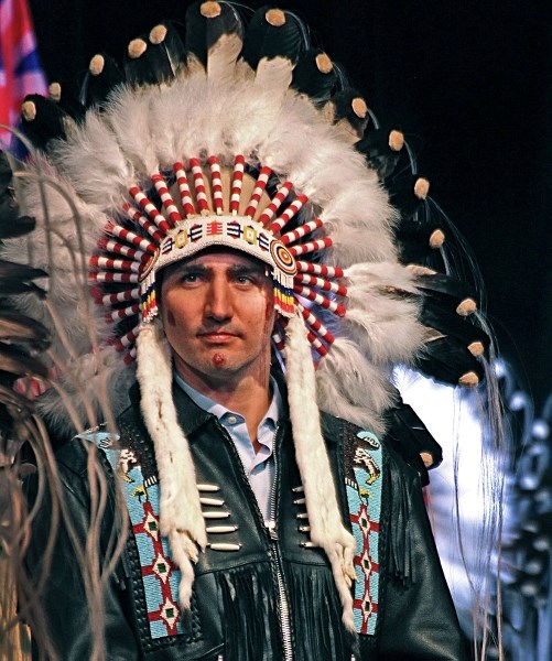 Prime Minister Justin Trudeau proudly wears his honorary headdress presented to him by the Tsuut&#8217;ina Nation at the Grey Eagle Casino on March 5. The First Nation gave