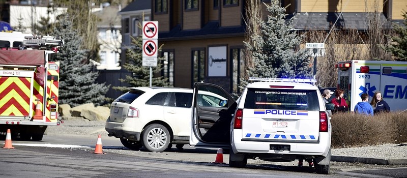 People involved in an auto accident are assessed by EMS officials following a collision at the intersection of River Avenue and Railway Street on March 4. No serious injuries 