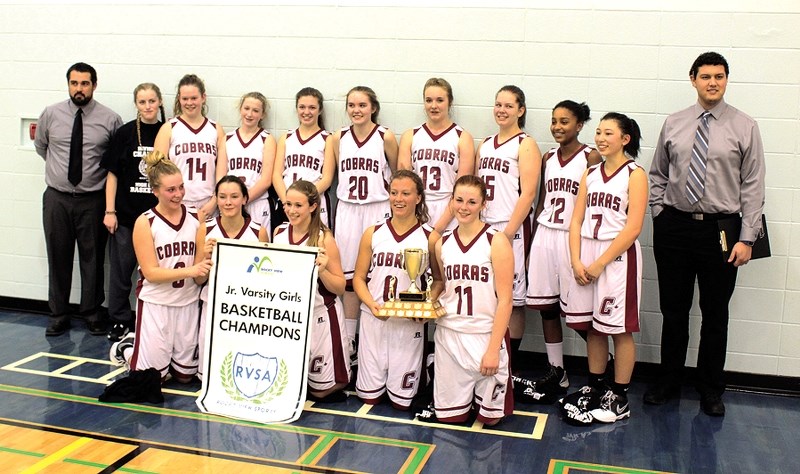 The Cochrane High School Cobras junior-varsity basketball girls show off their Rocky View Sports Association banner and trophy after beating Chestermere Lady Lakers 39-33 on