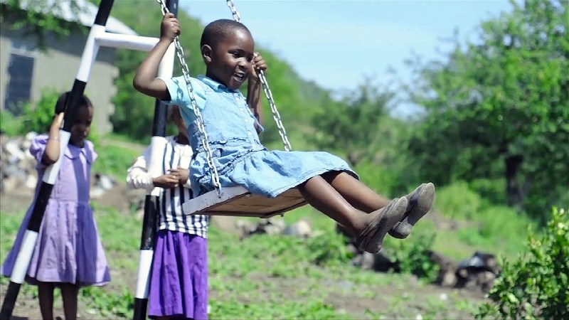 A youngster enjoys a swing on the Sue &#038; Martin Parnell Playground at Lindsay Kimmett Kindergarten School in Mto wa Mbu, Tanzania, Africa. Completed on March 1, the