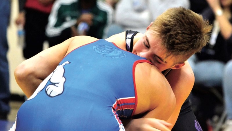 Cochrane Cowboys and Bow Valley High School wrestler Brendan Loeppky (right) during a match at the ASAA High School Wrestling Provincials over the weekend of March 12-13.