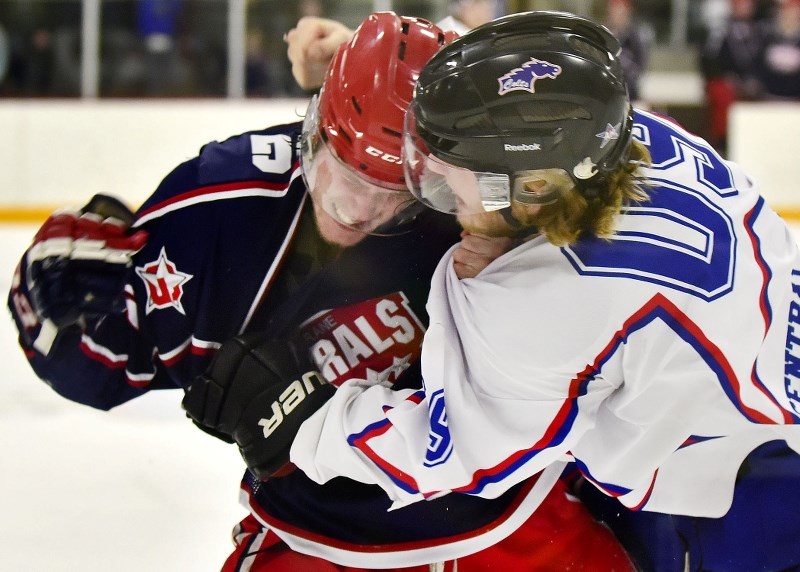 Cochrane Generals forward George King and Mountainview Colts forward Benjamin Strautman go at it in Game 5 of the HJHL final series March 22 in Cochrane. Colts won 5-4. The