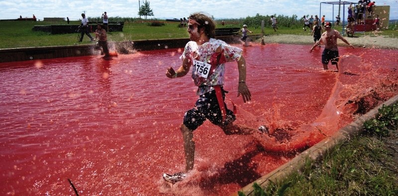 Connor Gray runs through a &#8220;pool of blood&#8221; at a past Zombie Survivor race at Cochrane &#038; District Agricultural Society. Registration for this year&#8217;s