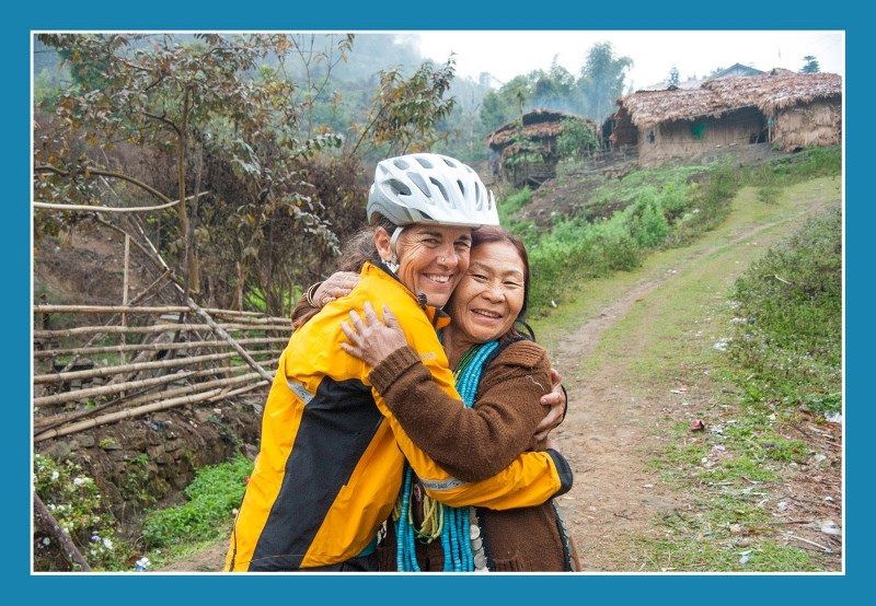 Before resuming her cycling trek across northern India with her husband, Bruce Roberts, Robyn MacKay receives farewell hug from their overnight host in a small tribal village 
