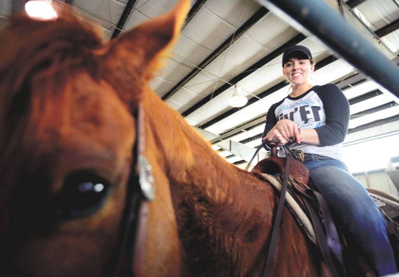 Candice Lee poses with her horse at the Cochrane Agricultural Society Grounds on April 1.