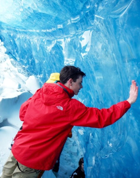 Tyson Wasylik, a student at Bow Valley High School, reaches out to touch glacier ice on the school&#8217;s field trip to the Saskatchewan Glacier in Banff National Park. The