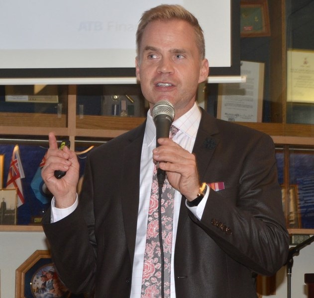 Todd Hirsch speaks at the Royal Canadian Legion in Cochrane on Monday.