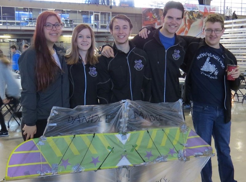 (From the left): Erin O&#8217;Leary, Eve Hebert, Noah Wttewall -Arteaga, Duncan Swedlo, and AJ Corcoran pose with the sail they built for one of the events they competed in