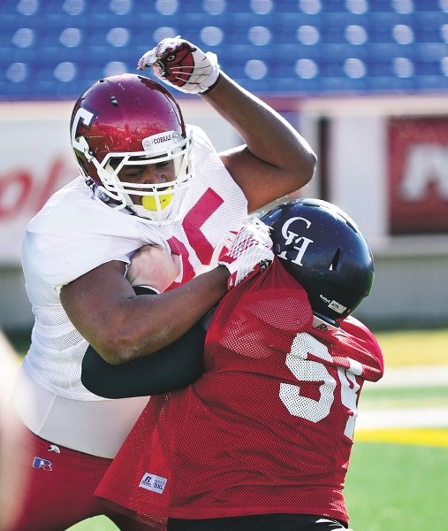 Cobras&#8217; Justin Sambu (left) in action during the Senior Bowl tryouts. By Ryan McLeod