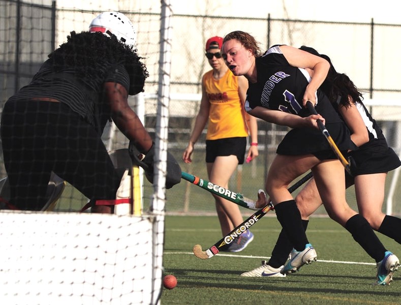 Sammi Aelsing (right) of the St. Timothy Thunder women&#8217;s field hockey team goes for goal during her team&#8217;s 5-0 victory over Bishop O&#8217;Byrne on April 21 at