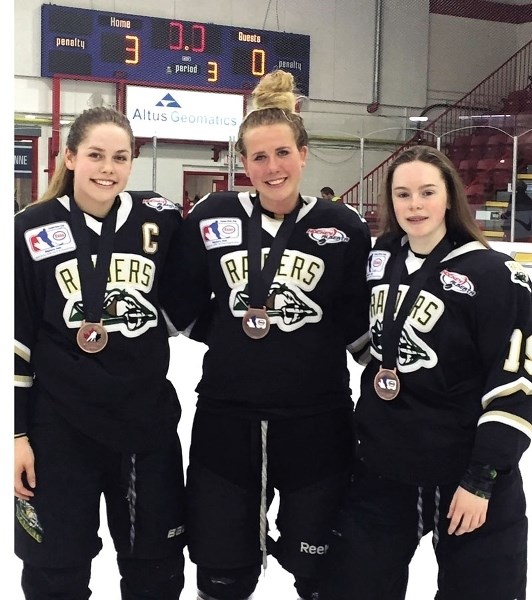 Cochranites (left to right) Nicolette Seper, Kara Kondrat, and Megan Campbell with their bronze medals at the Esso Cup in Weyburn, Saskatchewan on April 23. PHOTO BY ROCKY