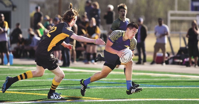 Austin Dixon carries in the try against Banff&#8217;s Duncan Thorburn. The Bears next face Foothills Composite High School at home. PHOTO BY RYAN MCLEOD