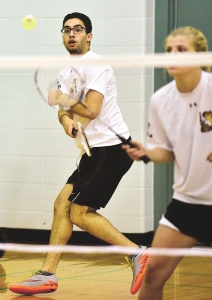 Cochrane High&#8217;s Chris Alain swipes across the winning shot in the Rocky View mixed doubles divisional playoff finals on April 23 with his teammate Taylor Chace. PHOTO