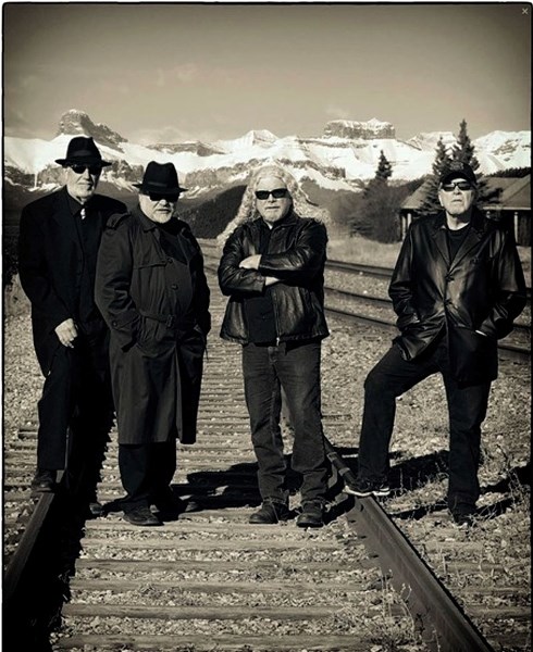 From left, John White, Barry Valgardson, Dave McRae, and Brian Burrows pose in front of the majestic Rockies.
