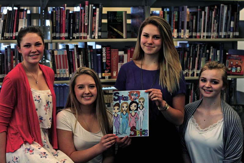 From left, Kennedy Michalski, Grace Kloster, Veronika Vrablik, and Delaney Wiebe pose with their comic, Spice Spies. The girls&#8217; comic was initially a school project