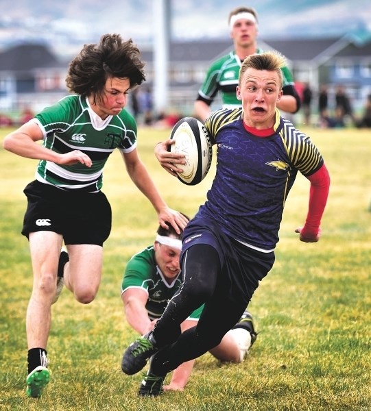 Rylen Waugh of the Cochrane Bears races up field against the Holy Trinity Academy Knights on May 5. Photo by Ryan McLeod