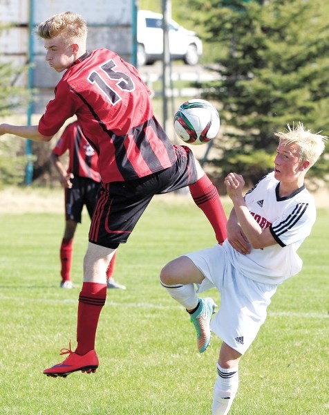 Cochrane High School Cobras boys soccer player James Keenan (right) tries to bring the ball under control during his team&#8217;s 3-2 win over the Chestermere High School