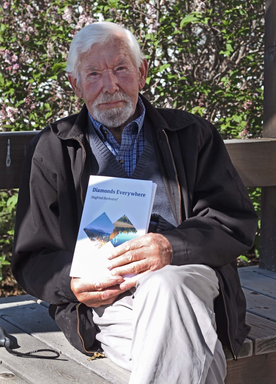 Siegfreid Beckedorf poses with his book, Diamonds Everywhere. The book is an autobiography dedicated to his late wife Ursula.