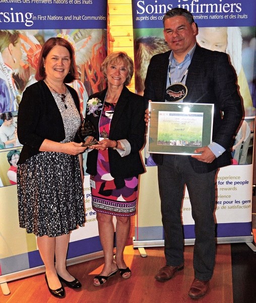 Stoney First Nation nurse Joyce Ball (middle) receiving her award for Canada&#8217;s 14th annual First Nations and Inuit Health Branch Award of Excellence in Nursing from