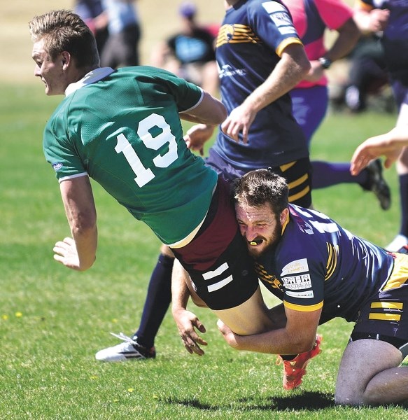 Bow Valley Grizzlies rugby player Mackenzie Tivendale (right) crunches into a tackle during his team&#8217;s 38-26 loss to the Calgary Irish on May 28. The loss was the