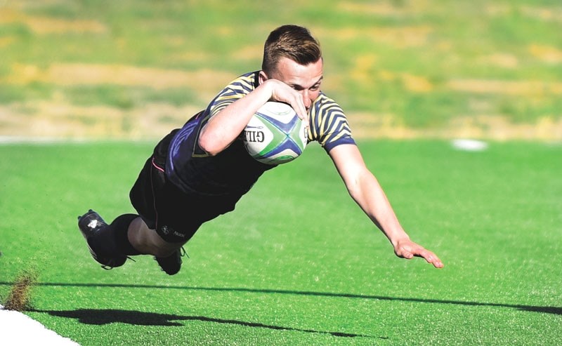 Cochrane Bears star Rylen Waugh flies in for a try during his team&#8217;s 27-12 victory over Strathmore High School on May 25 at the Calgary Rugby Union field. The victory