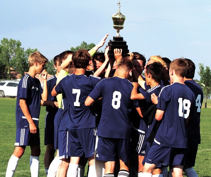 Bow Valley Bobcats players hold the Rocky View Sports Association Divisional trophy aloft for the first time in their school&#8217;s history after a fantastic 5-3 win over