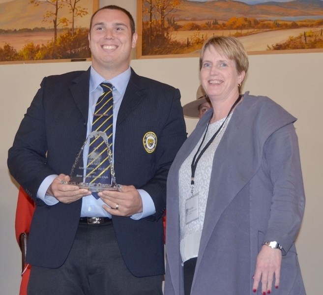 Bow Valley Rugby Club Vice-President Anthony Battistone accepts the club&#8217;s Ambassador of the Year award from Fiona Gilbert during the Cochrane Community Awards on June