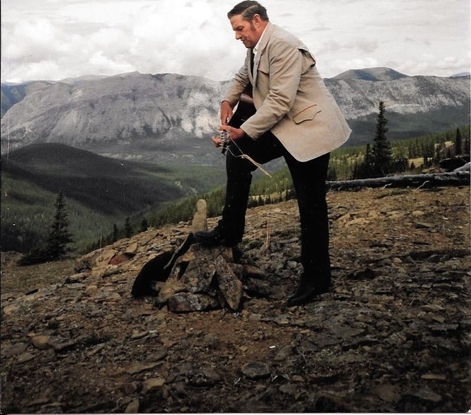 Bobby Turner plays guitar during a funeral service for Carl Bundt at the top of Switchback Hill in 1991.