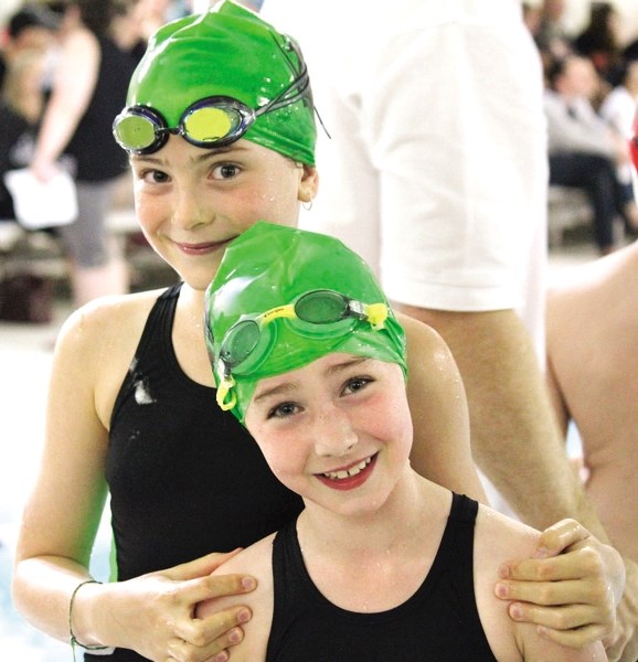 Piranha swimmers Josie Powers (left) and Kaitlyn Eiserman at the High River Ottors Swim Meet on June 25.
