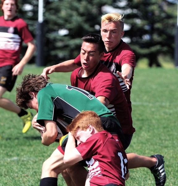 Cochranites Austin Dixon and Rylen Waugh attempt to bring down a Saskatchewan Rugby player during their victory at the Alberta Regional Competition.