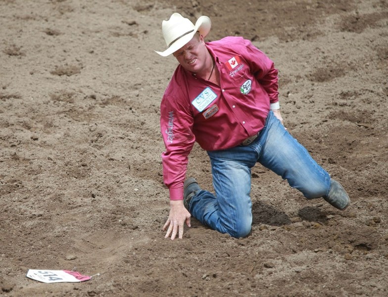 Tanner Milan grimaces after his steer wrestling run at the 2016 Calgary Stampede Rodeo on July 9. The Cochranite is the only local cowboy participating in this year&#8217;s