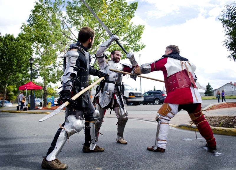 The Real Knights from Ironhart Vanguard practice their fighting skill at the Cochrane Street Market in Historic Downtown last Thursday. The three knights are preparing for