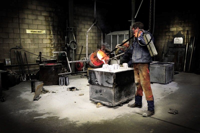 Don Begg and crew pour bronze into molds at Studio West Bronse Foundry and Art Gallery Aug. 9. The studio is currently doing maintenance work on the Wayne Gretzky statue they 
