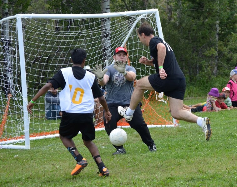 Sami Issak, 16, from St. Francis High School in Calgary, dives for the save during the priests versus high school students soccer game. The priests battled back from a 2-0