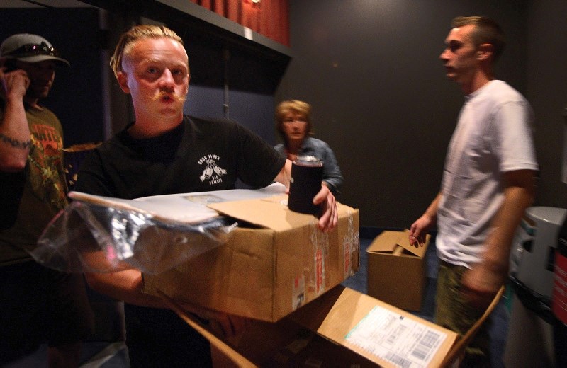Filmmaker Liam Glass carries in a box of door prizes at the premiere of skateboard movie Beerstorm 2, which features Steven Graham and Riley Sykes, both from Cochrane, on