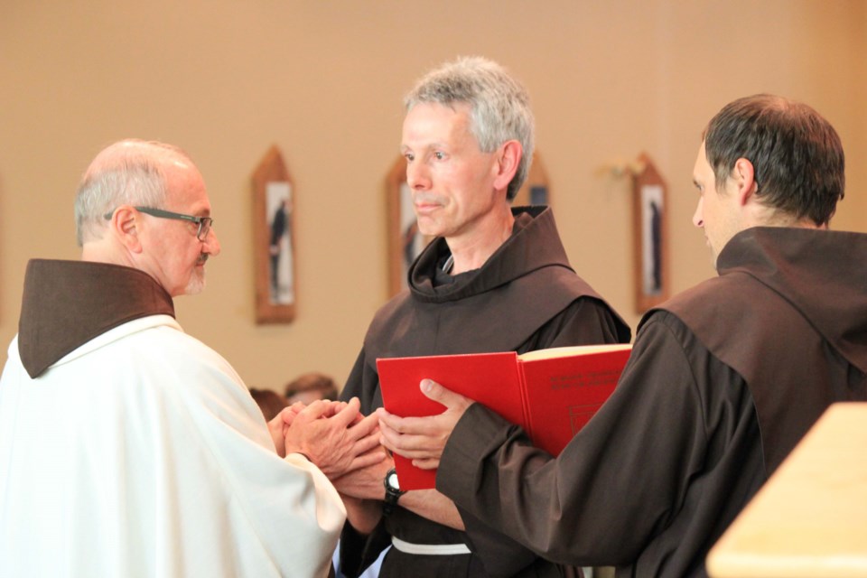 A ceremony for Father Joseph Francis Glaab (centre) was held at St. Mary&#8217;s Catholic Church Aug. 19, as he declared his solemn vows of chastity, poverty and obedience to 