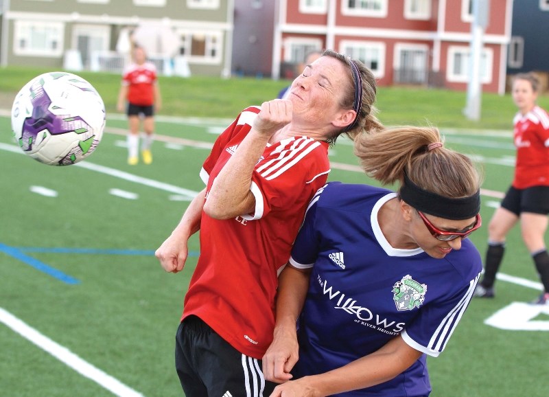 Nancy Blystone (left) goes up for a header during the Cochrane Rangers 3-1 win over the Cochrane Soccer Club in women&#8217;s over-40 tier two action on Aug. 21 at Spray Lake 