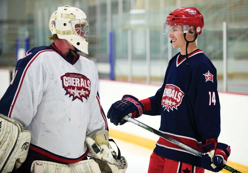 Ty Robinson and defensemen Logan Brown chat at the start of Cochrane Generals Training Camp on Sept. 3 at Spray Lake Sawmills Family Sports Centre Totem One arena.
