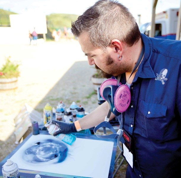 Steve Gervais works on a piece at the Night Market in Historic Downtown.