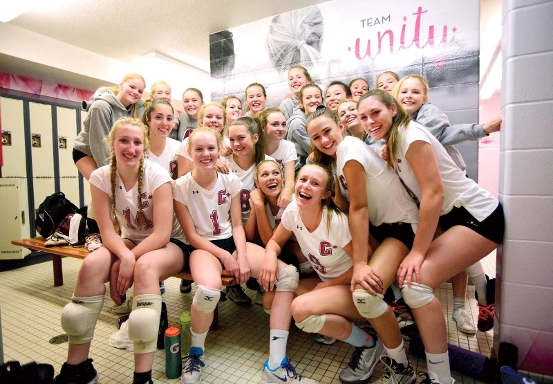 Cochrane High School&#8217;s junior and senior girls volleyball teams pose for a team photo in their newly renovated dressing room on Sept. 13.