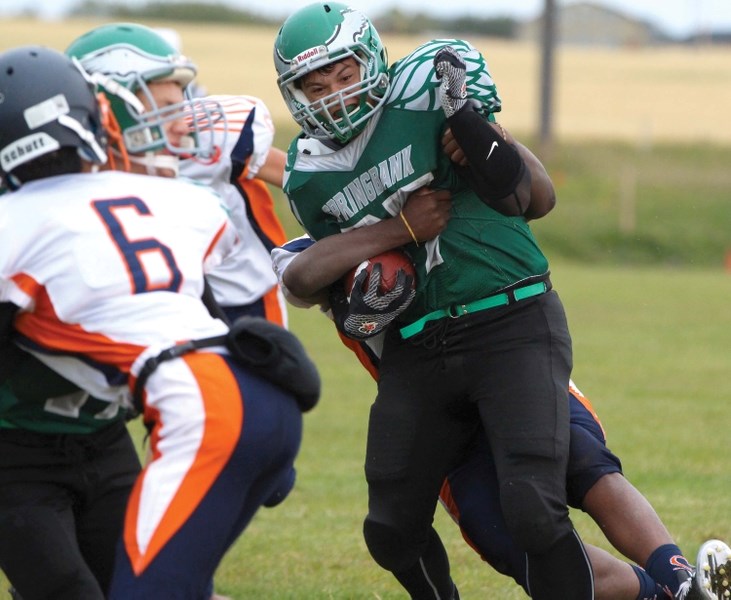 Springbank Community High School running back David Taylor tries to smash his way through the WH Croxford defence during his team&#8217;s 26-0 home win on Sept. 8.