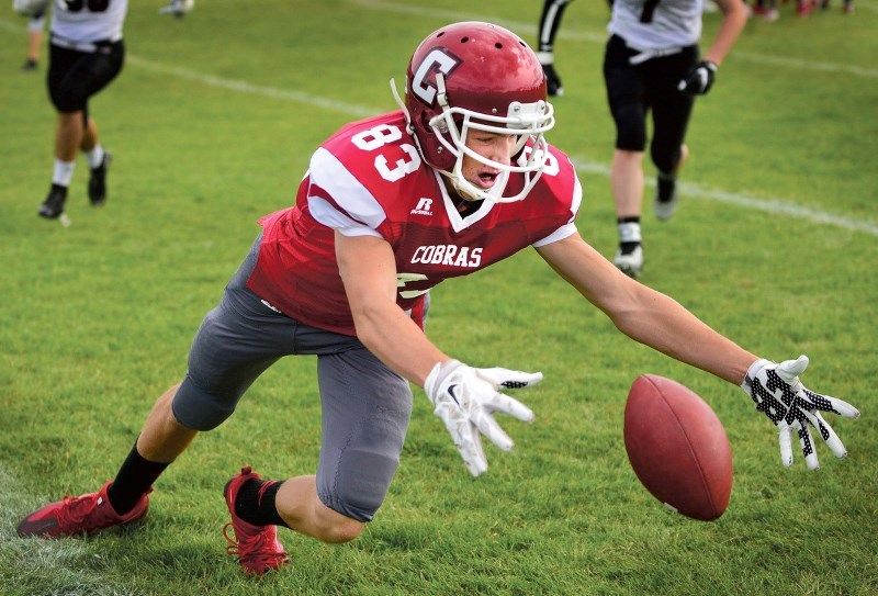 Daniel de Bruin leaps on a loose ball as the Cochrane High Cobras took on the Foothills Composite Falcons in exhibition play on Sept. 10.