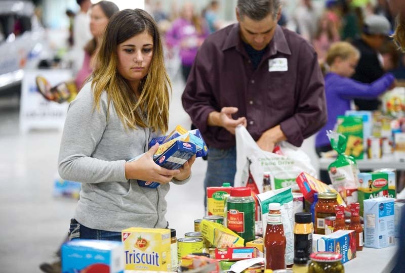 Maddy Bujold celebrated her 13th birthday by helping out at the Helping Hands Society of Cochrane &#038; Area food drive on Sept. 17.