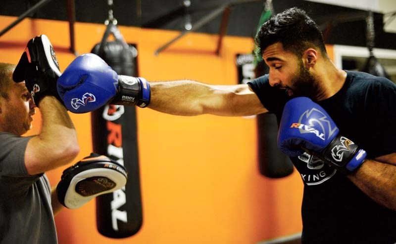 Craig Wilson, left, trains Usama Khan, a Super Heavyweight boxer on Sept. 15 at Rival Boxing Gym.