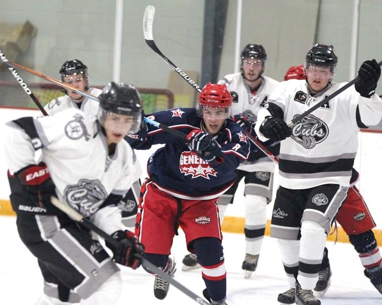 Ty Milligan chases after a puck while surrounded by Medicine Hat Cubs players during his team&#8217;s 5-1 win on Sept. 17.