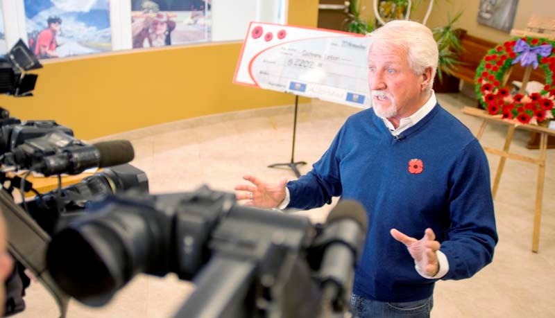 Dan Kroffat shows off the generous donations from the public totalling $2,202 on November 20. After 39 poppy boxes were stolen.