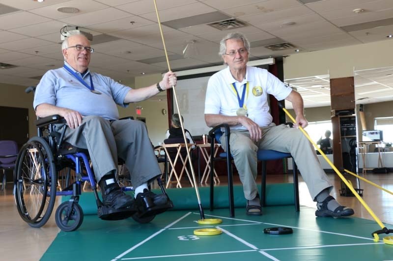 Dan Stuehrenberg, left, and Doug Campbell won gold in the floor shuffleboard Alberta 55+ Provincial Games.